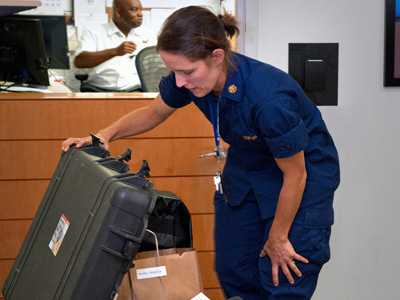 Photo: CDC Disease detective Rebecca checks her trunk before deploying to West Africa.