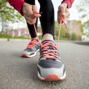 image of a person tying their laces on their sneakers