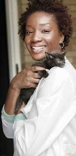 a veterinarian holding a kitten