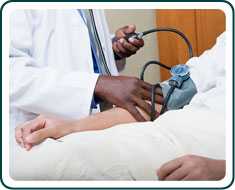 A patient having their blood pressure taken by a doctor.