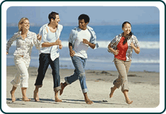 People running on a beach.