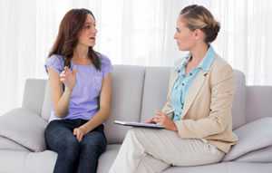 Photo of a young women talking to a genetic counselor