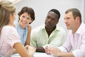 Photo of four people in a meeting