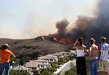 Photo of people looking at a wildfire.