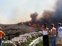 Photo of people looking at a wildfire.