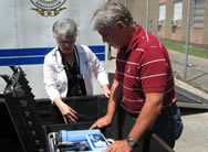 Emergency response staff reviewing steps to use a water purification unit.