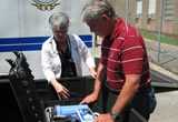 Emergency response staff reviewing steps to use a water purification unit.