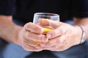 man holding glass of liquor