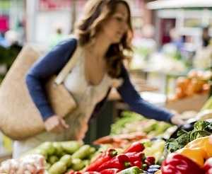 lady choosing fresh vegetables in market