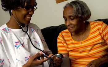 woman nurse with an older woman patient