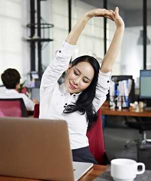 woman stretching at desk