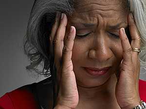 	Mature woman with head in hands and eyes closed - Mental Health