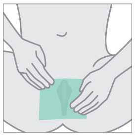 Hands holding dental dam over vulva.