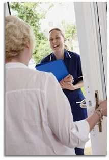 A CHW visiting an elderly woman at her home.