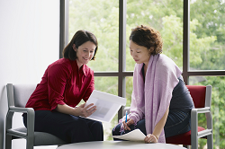 Two CHWs going over some paperwork.