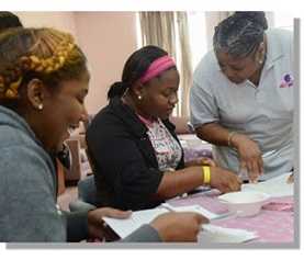 A CHW talking to some women about healthy behaviors.