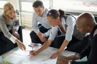 A group of people reviewing documents on a shared table