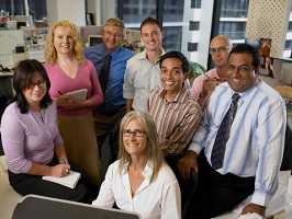 Group of office workers gathered around a desk