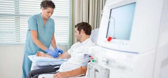 nurse giving a seated patient an injection