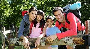 	A family hiking in the woods with backpacks