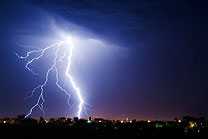 Lightning striking over a city sky