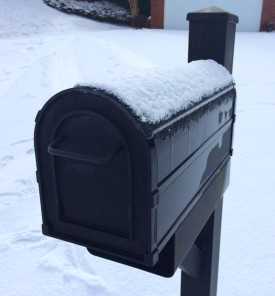 Curbside Mailbox with Melting Snow on Its Top