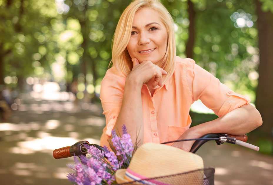 Older woman on bicycle, smiling