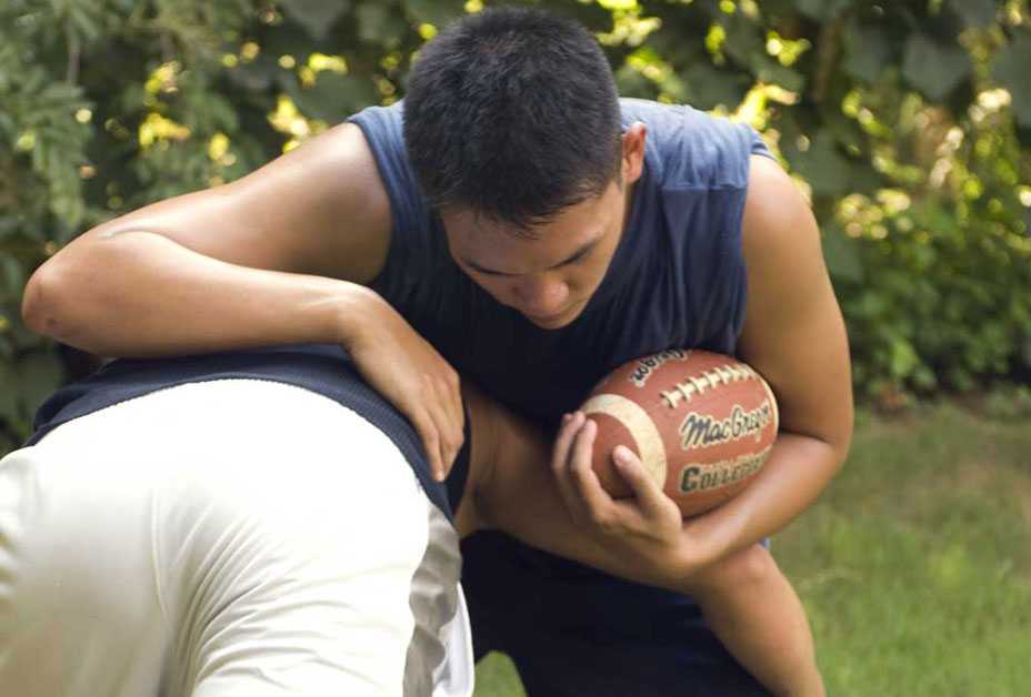 Two boys playing football