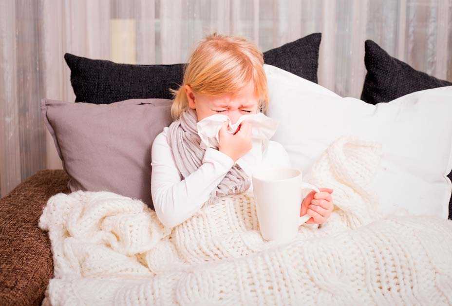 Young girl blowing nose