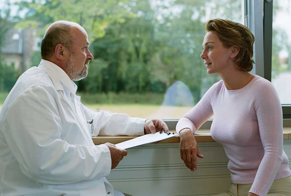 Woman talking with doctor