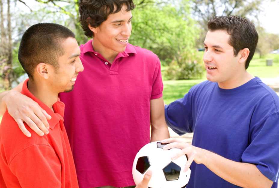 Three men playing soccer