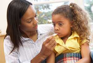 Mother taking daughter's temperature