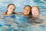 Three girls swimming