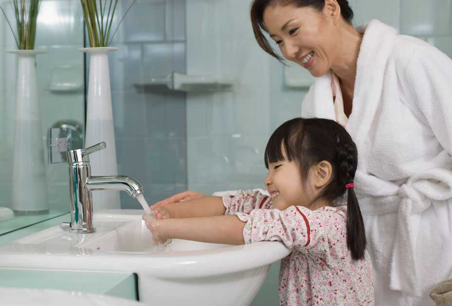 Mother and daughter washing hands