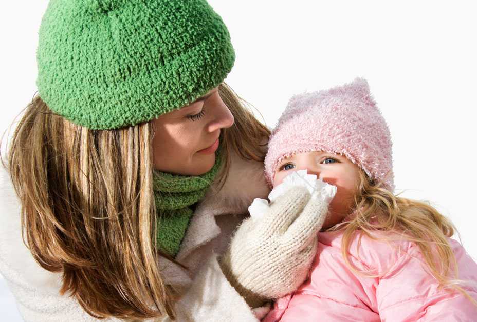 Mother wiping daughter's nose