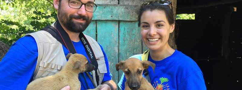 Dr. Ryan Wallace and Dr. Alexandra Medley holding a dog.