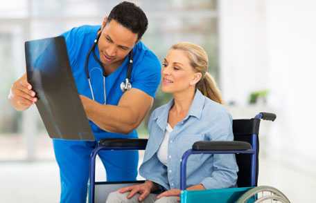 Doctor showing an x-ray to a woman in wheelchair