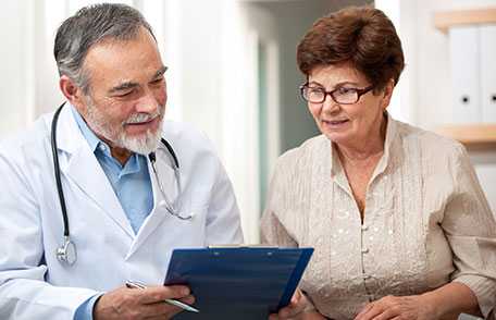 Doctor and patient looking at clipboard