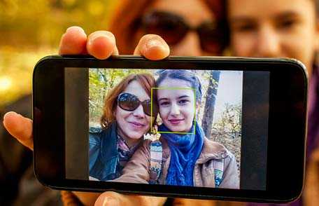 Mother and daughter taking selfie with smartphone
