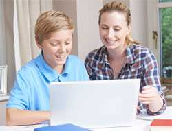 Mother and son looking at laptop