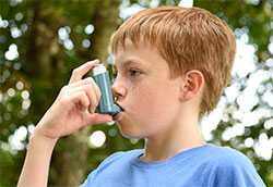 Boy using inhaler