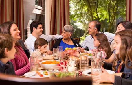 Photo: Family sharing meal at dining table