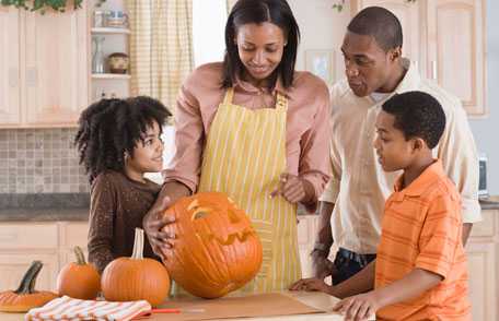 Three children with pumpkins