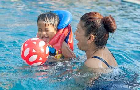 Mother and son enjoying swimming pool