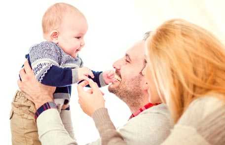 Mother and father playing with baby