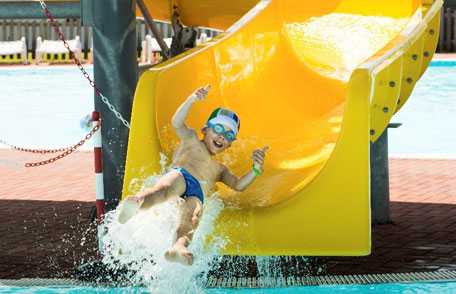 Young boy on water slide