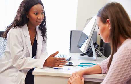 Doctor talking with female patient