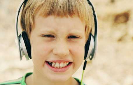 Boy wearing headphones and smiling