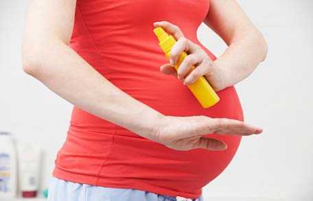 Woman using insect repellent