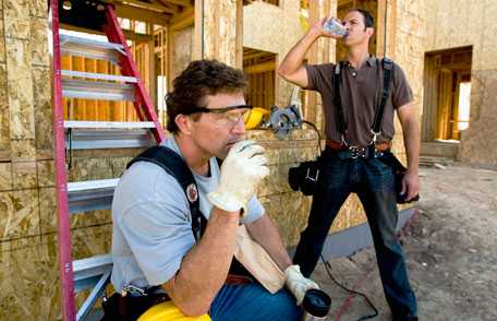 Construction workers taking break and drinking water